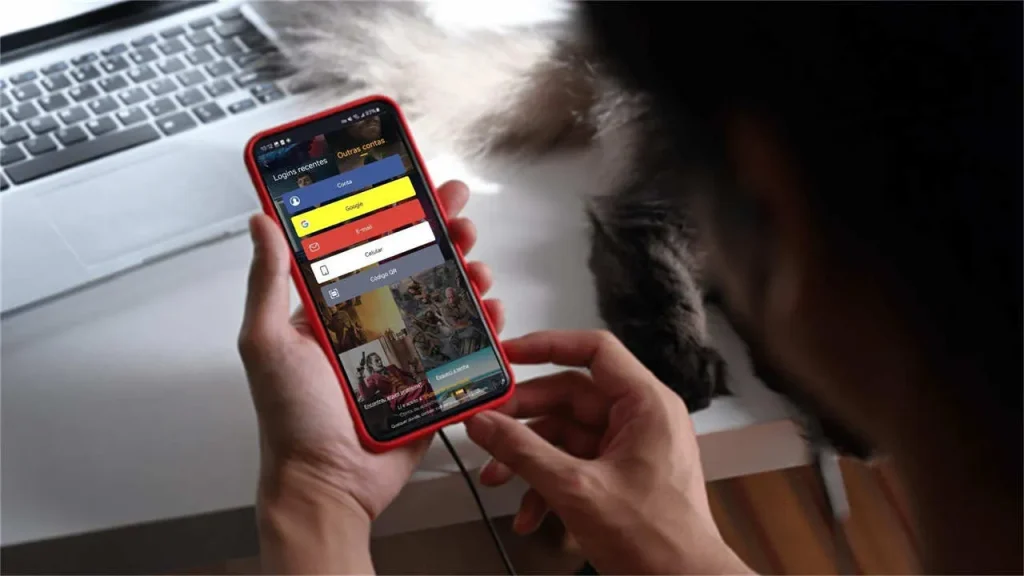 A man holding a phone, opening the Youcine app on the screen.